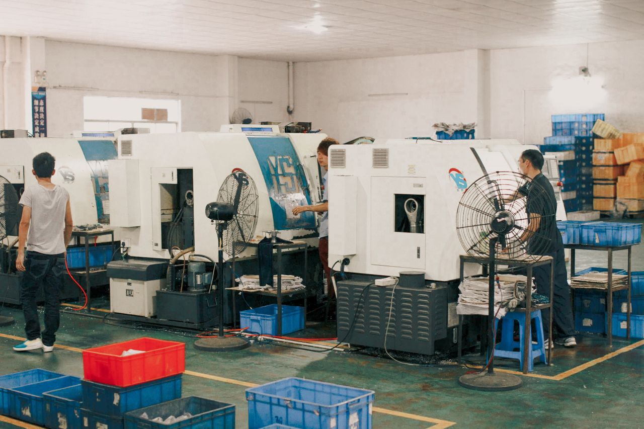 The Art of Drawing Readers In: Your attractive post title goes here Workers operating machinery in an industrial factory setting, showcasing manual labor and production.